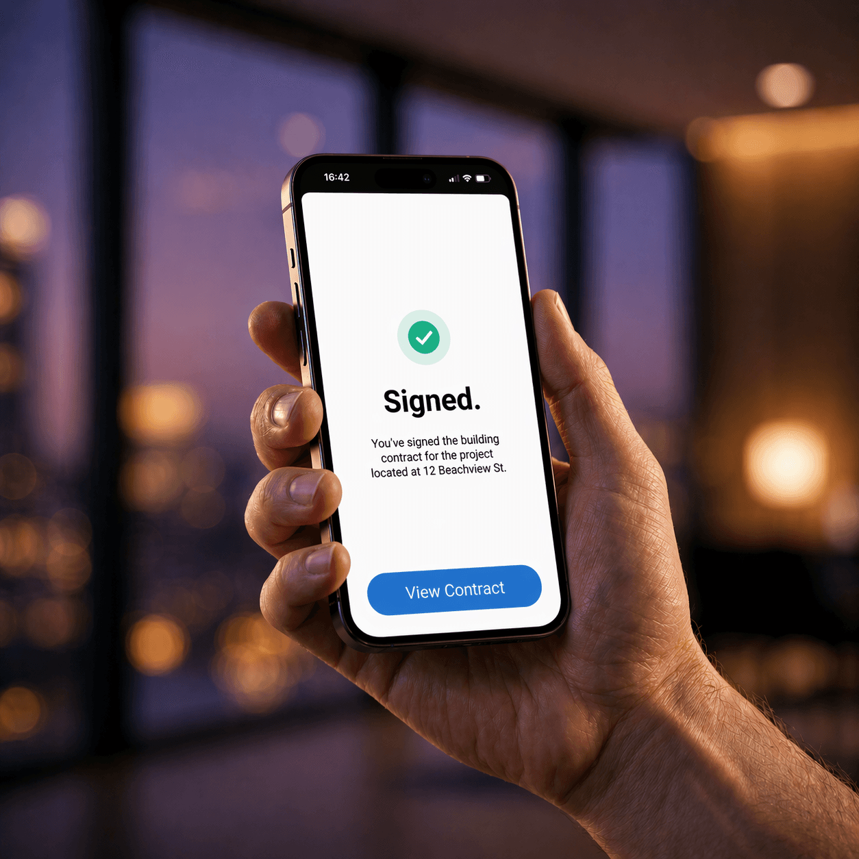 Hand holding smartphone with contract signed confirmation